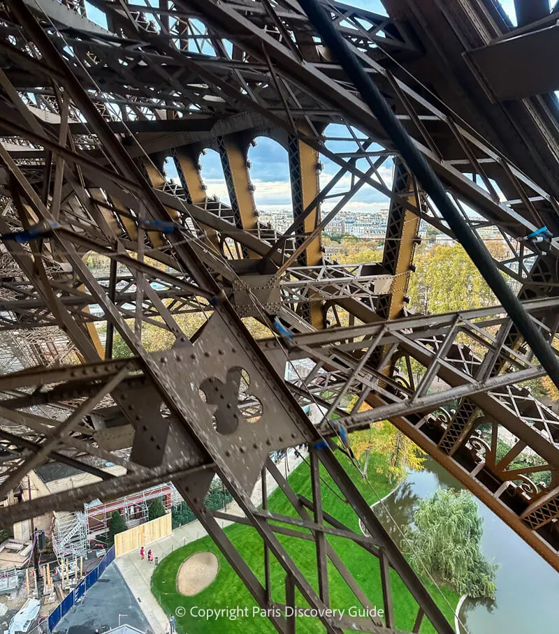 How to Get Eiffel Tower Tickets: 8 Easy Ways to Avoid Standing in Long Lines View from the Eiffel Tower's stairs between the ground and the 1st Level
